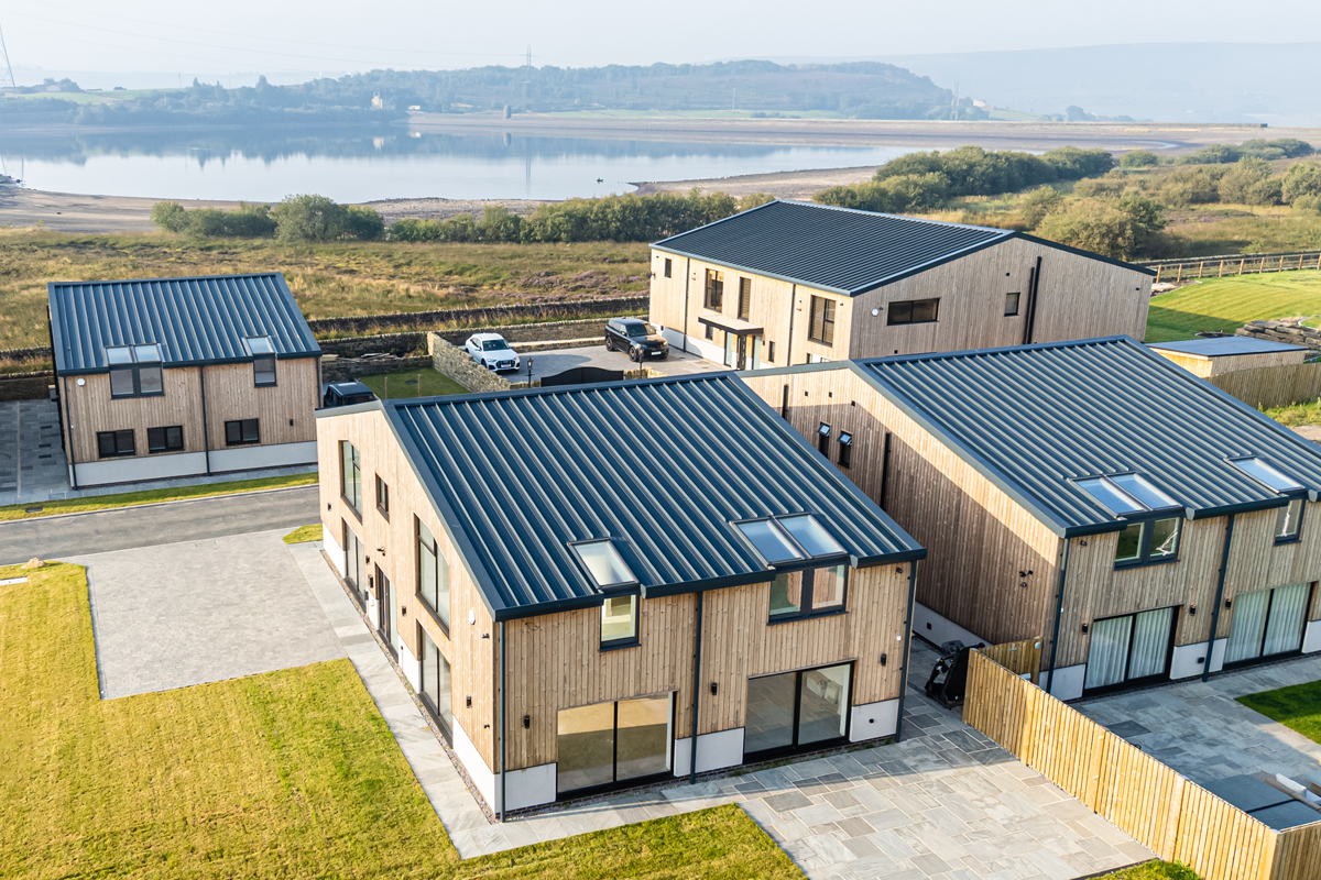  Aerial view of luxury homes at Peat Pitts Farm with Cladproof roofing set in rural landscape 